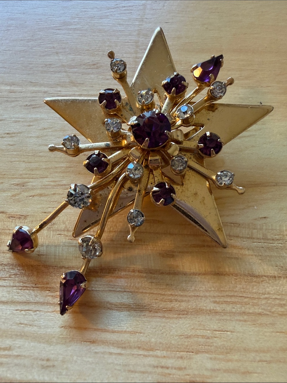 Gold-Tone Starburst Brooch with Purple and Clear Stones